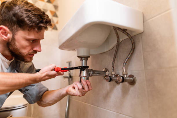 istock A plumber carefully fixes a leak in a sink using a wrench 1516511015