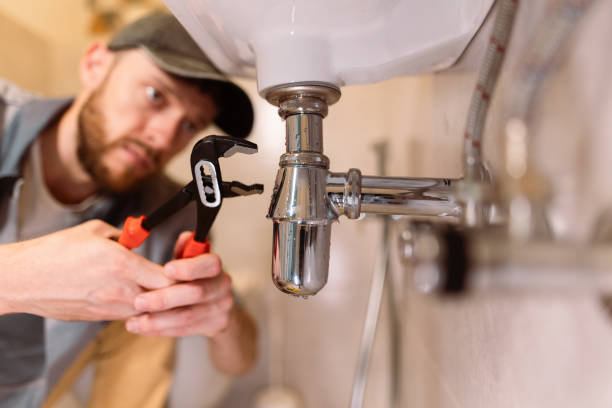 istock A plumber carefully fixes a leak in a sink using a wrench 1516511540