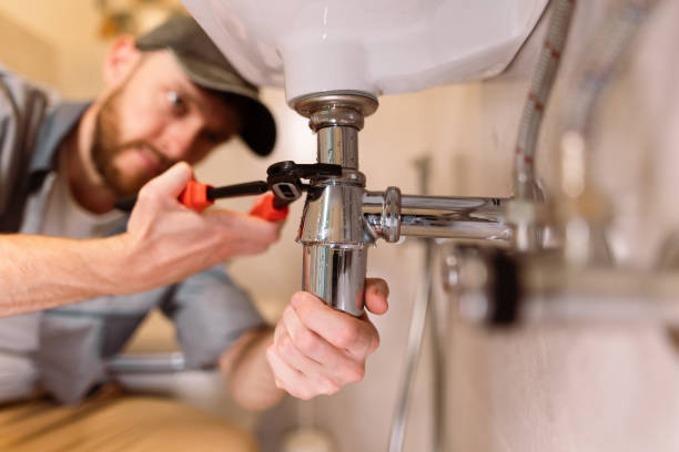 istock A plumber carefully fixes a leak in a sink using a wrench 1516512057