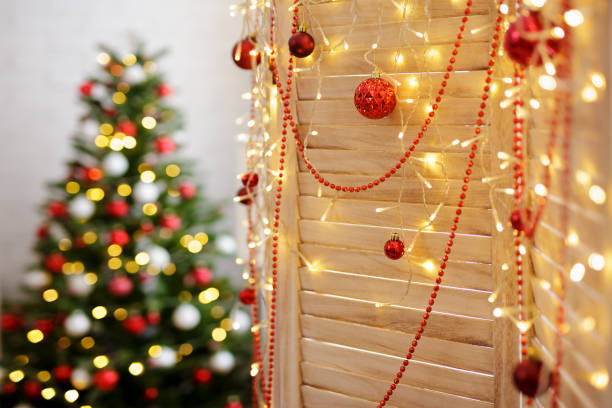 istock wooden folding screen decorated with led garland and red baubles 1516517088