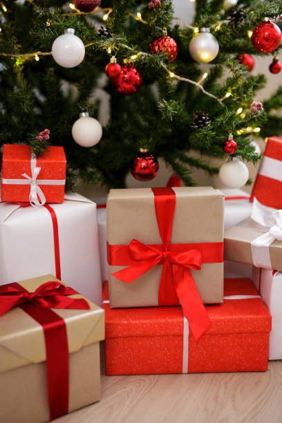 istock close up of gift boxes and decorated christmas tree 1516517126