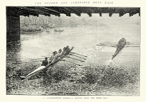 Vintage illustration of Passing under Hammersmith Bridge during the 29th Oxford and Cambridge university boat race of 1872, during a snow storm, Cambridge in the lead