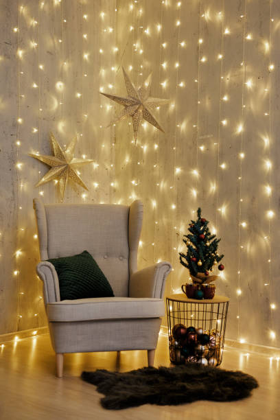 istock Christmas background - armchair and Christmas tree over wall with led lights 1516545986