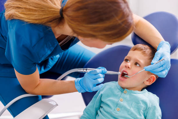 istock Dentist fixing child patients tooth 1516563760