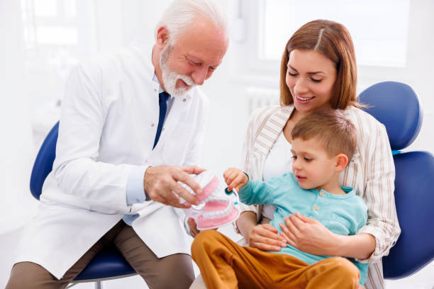 istock Dentist educating child how to brush teeth properly 1516566297