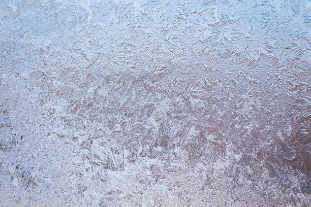 istock Winter ice pattern on the frozen window. 1516569560