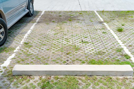 Lines parking on brick and grass background