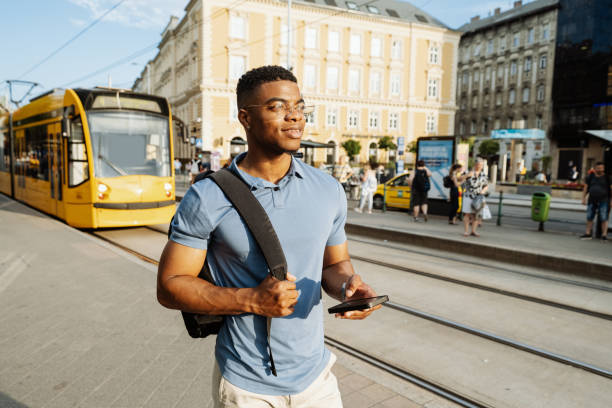 istock Millennial businessman going from work by yellow tram 1516579461