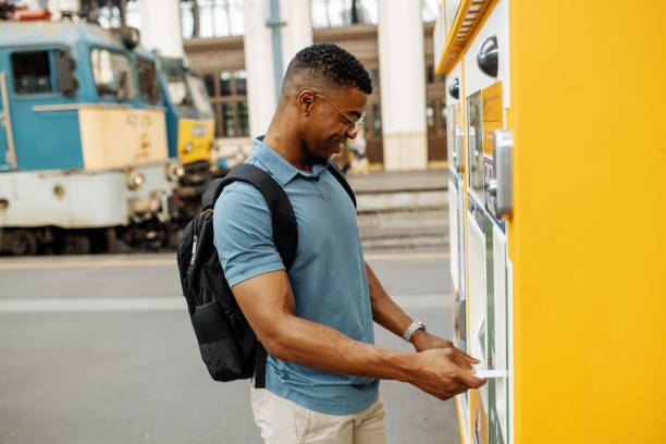 istock Millennial African-American going to work, buying a train ticket on the vending machine and paying contactless 1516580005