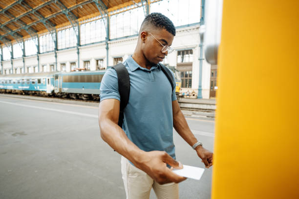 istock Millennial African-American going to work, buying a train ticket on the vending machine and paying contactless 1516581114
