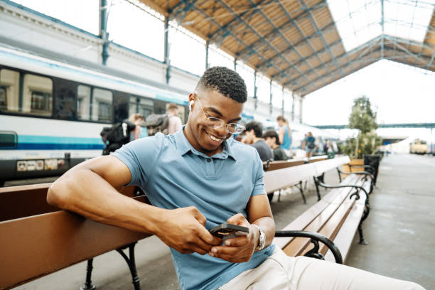 istock Millennial African American entrepreneur going to work and using smart phone, man has earphones and listening to music 1516584382