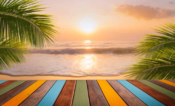 istock empty new wood table and tropical beach with coconut palm tree in background 1516592232