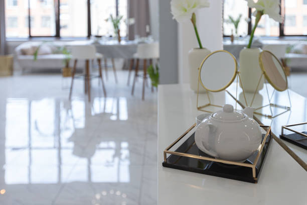 istock minimalistic light elegant luxury design of a modern spacious studio apartment with kitchen area, bedroom and huge mirror behind the couch. tiles on the floor and high ceiling. 1516608038