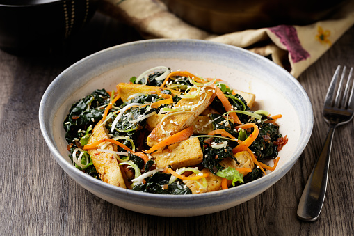 Homemade vegan tofu, carrot, kale stir fry with homemade XO sauce, roasted sesame seed for garnish.