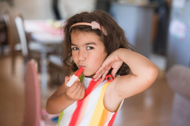 Girl playing pretend with plastic make-up toys