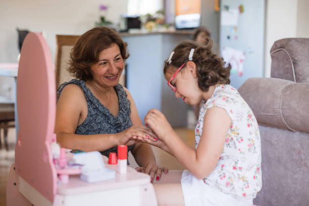 istock Girl using nail polish when playing with her mom 1516609029