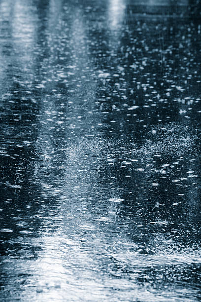istock Background of black pavement being rained on heavily 151661505