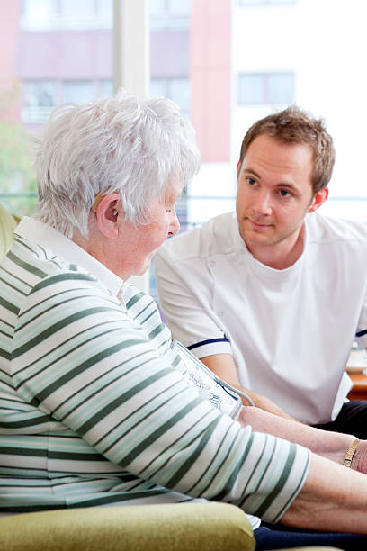 istock Nurse checking senior ladys blood pressure 151661618