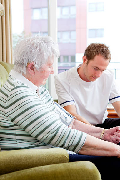 istock Nurse checking senior ladys blood pressure 151661627