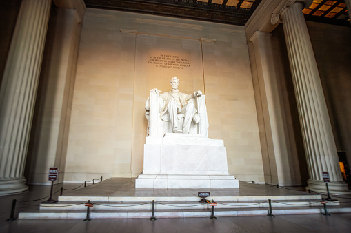 Columns surrounding the famous white marble statue of Abraham Lincoln within the Lincoln Memorial National Monument in Washington DC.