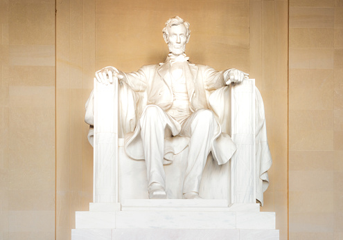 Detail of the marble statue of Abraham Lincoln within the Lincoln Memorial National Monument in Washington DC.