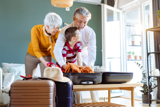 istock Senior couple and their grandchild packing for a trip 1516632901