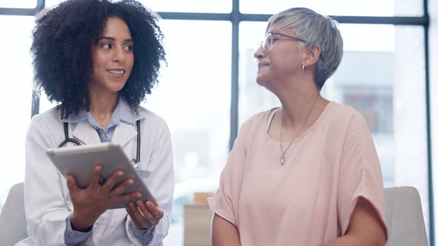 Medical, tablet and a woman talking to a patient during consulting with a doctor for insurance. Healthcare, trust and diagnosis with a female medicine professional explaining treatment to a senior