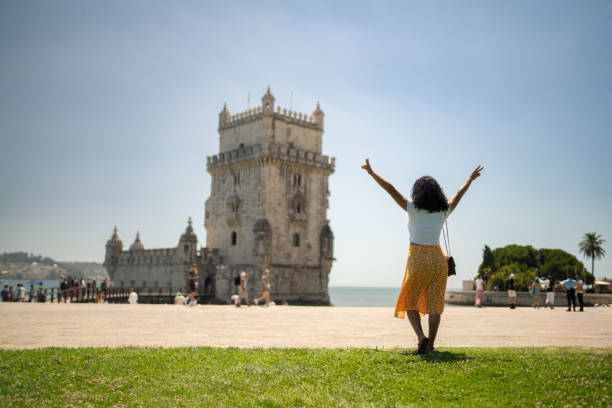 istock Tourist with open arms looking at Belem Tower 1516639732