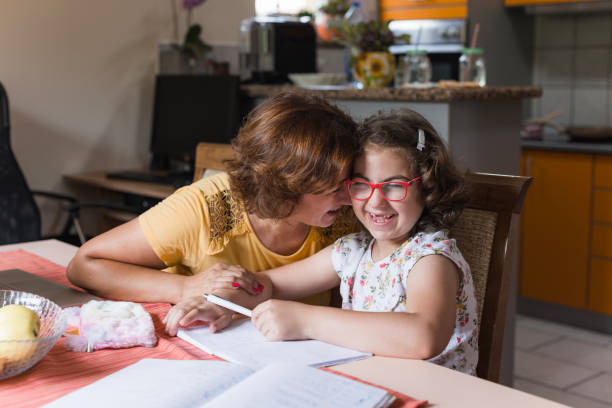 Woman leaning towards her daughter's face when sharing a laugh with her