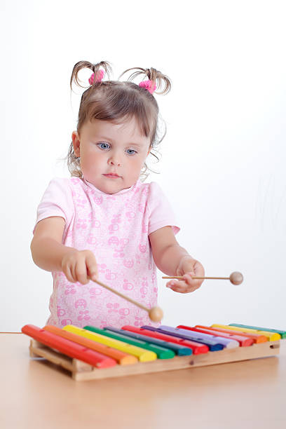 istock Little girl plays on xylophone 151664679