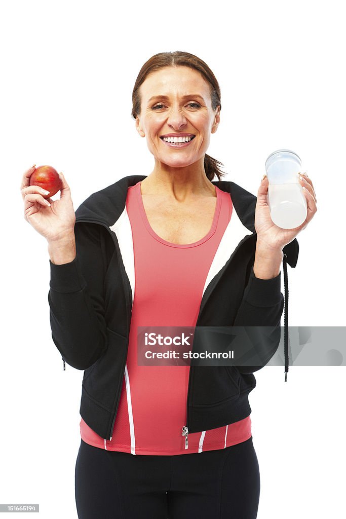 Mature woman isolated on white background with scales Senior woman in sportswear ready for exercise. Isolated on white and good for cutout. 50-59 Years Stock Photo