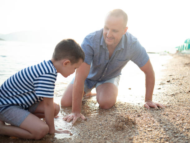 istock Father having fun with son on summer beach vacation. 1516665499