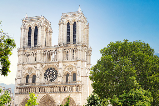 A close up photograph of the front of the Notre-Dame de Paris Cathedral on a sunny day.