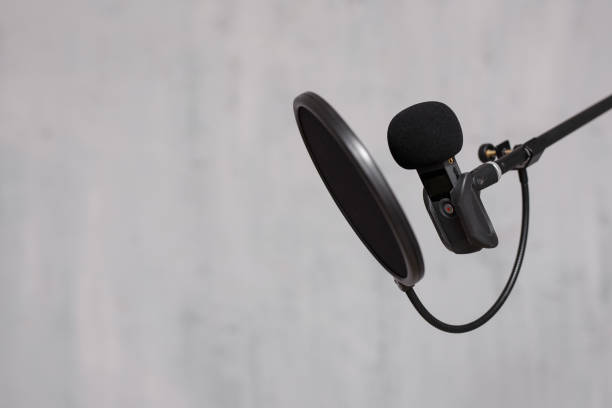 istock creativity, content making, podcast and blogging concept - microphone and pop filter over grey background 1516689135