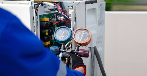 istock air conditioner technician using manifold gauge checking refrigerant for filling home air conditioning and air duct cleaning and maintenance outdoor compressor unit. 1516691899