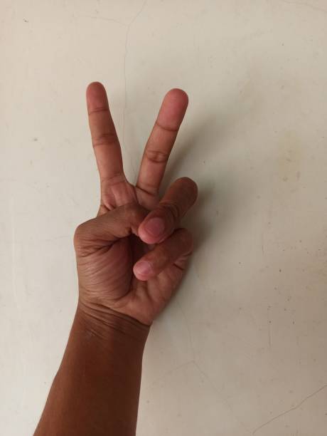 istock photo of a human hand against a plain wall background 1516693534