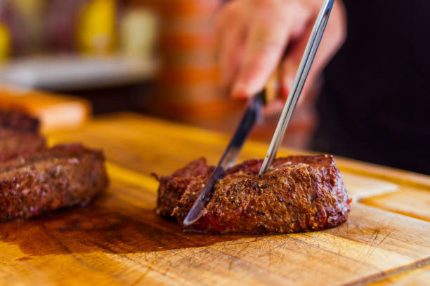 istock A Man Chopes A Beef Shoulder In A Wood Board 1516693547