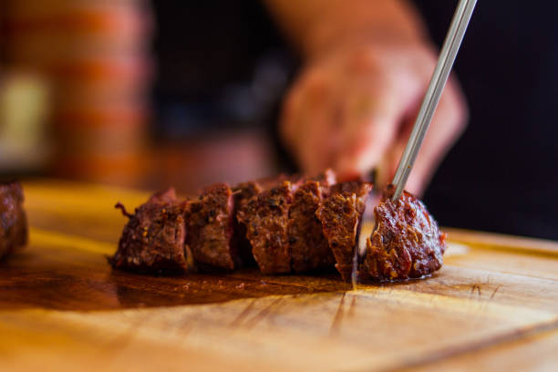 istock A Man Chopes A Beef Shoulder In A Wood Board 1516694059