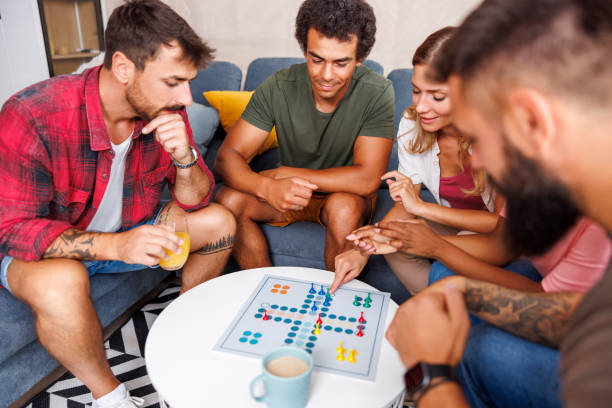 istock Friends having fun playing ludo board game at home 1516703464