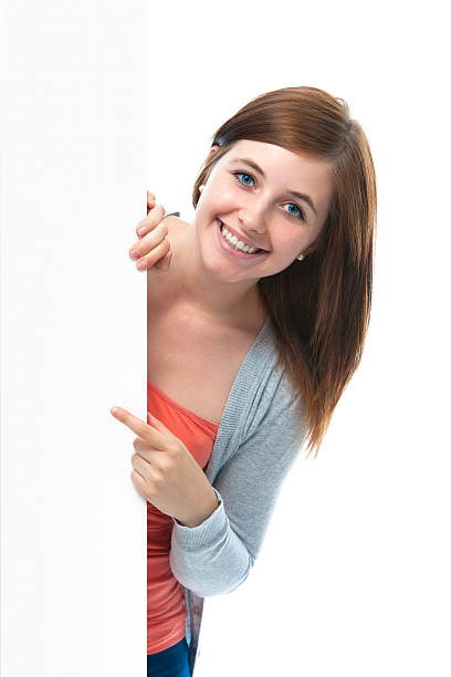 istock teenage girl points her finger at a blank board 151670812