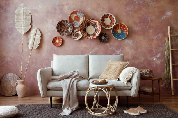 istock The stylish boho compostion at living room interior with design beige sofa, coffee table, wicker baskets and elegant personal accessories. Brown and white pillows and plaid. Cozy apartment. Home decor. 1516720944