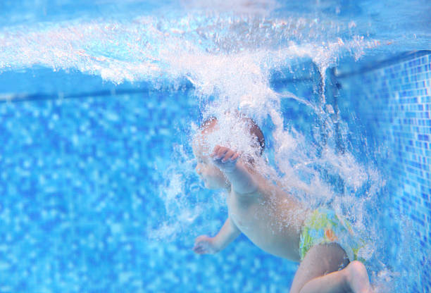 istock Little boy after diving into a swimming pool 151677432