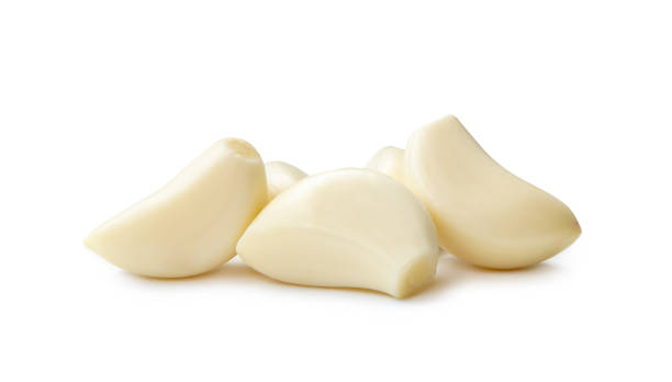 istock Peeled garlic cloves in stack isolated on white background with clipping path 1516797888