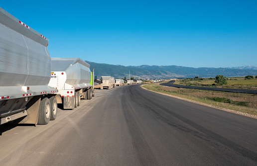 Long line of trucks on freeway under construction. Kaysville, Utah.