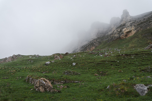 mountains and rocks in fog in summer
