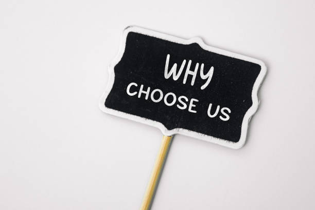 istock Why choose us - text on a small chalkboard on a neutral background. Top view. Concept meaning list of advantages and disadvantages to select product or servic 1516839266