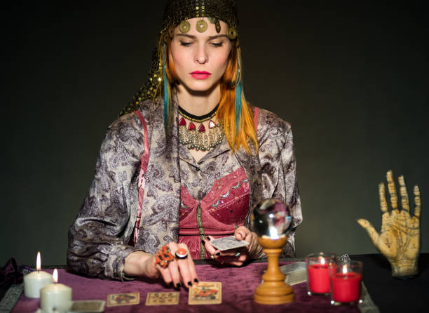 istock Fortune teller reading tarot cards in dark room 1516841295
