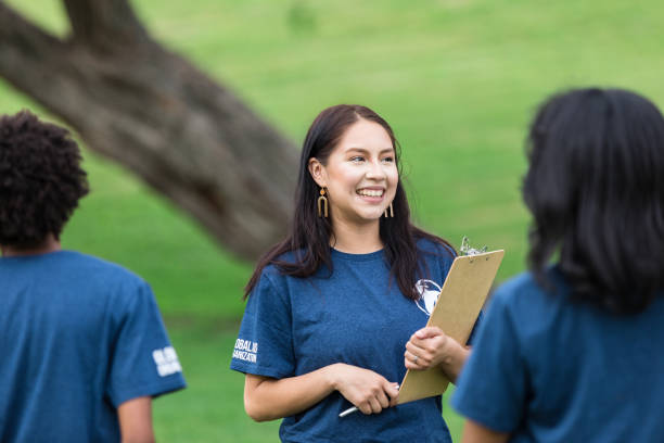 istock Smiling young adult event coordinator carries clipboard 1516845934