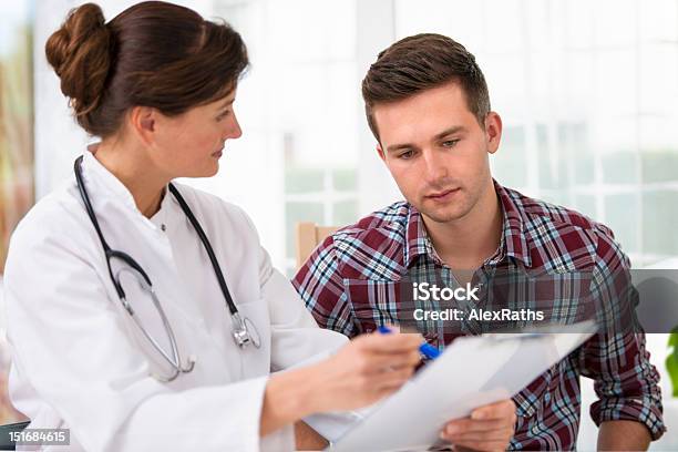 Doctor With Male Patient Stock Photo - Download Image Now - Doctor, Patient, Teenager