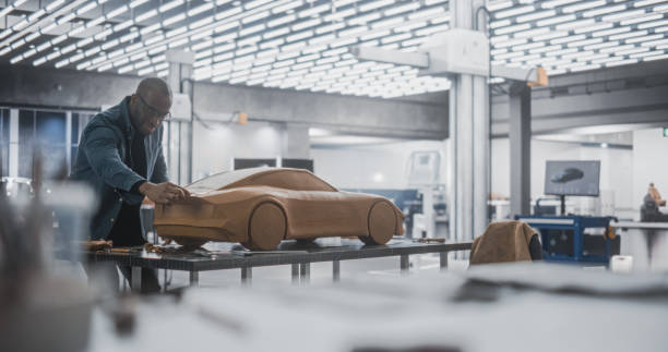 istock African Automotive Designer Using Spatula to Create a Prototype Car Out of Polymer Modeling Clay. Focused Black Modeler Working in a Research and Development Studio at a Vehicle Production Factory 1516858441